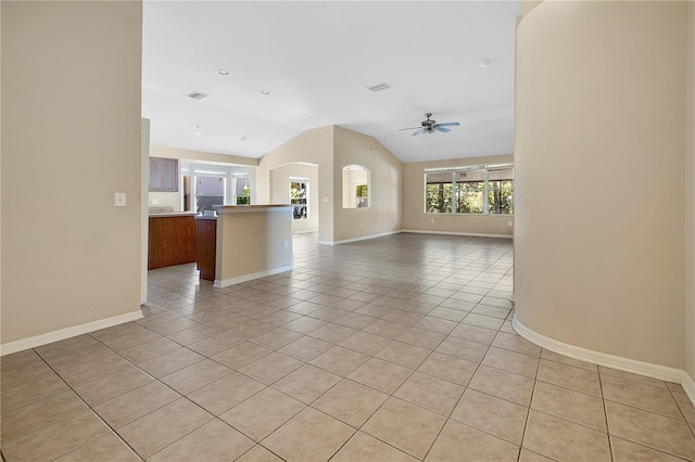 unfurnished living room featuring ceiling fan, light tile patterned floors, and lofted ceiling