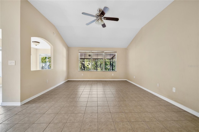 empty room featuring ceiling fan, light tile patterned flooring, and lofted ceiling