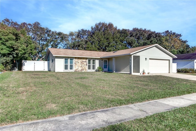 ranch-style house with a garage and a front lawn