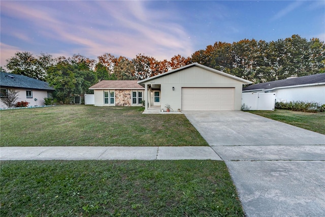 ranch-style house with a lawn and a garage