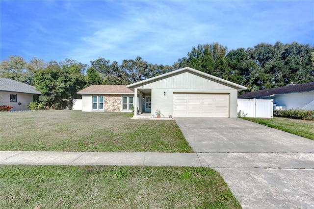 ranch-style house featuring a front yard and a garage