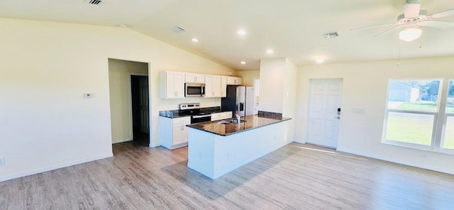 kitchen featuring lofted ceiling, white cabinets, light hardwood / wood-style floors, kitchen peninsula, and stainless steel appliances