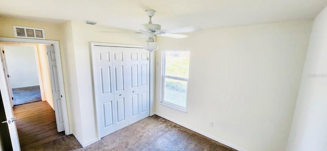 unfurnished bedroom featuring carpet, ceiling fan, and a closet