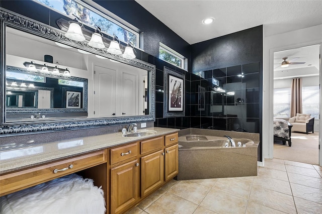 bathroom featuring a bath, tile patterned floors, a wealth of natural light, and vanity