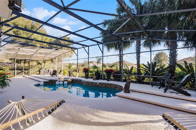 view of swimming pool with a patio area, glass enclosure, and a mountain view