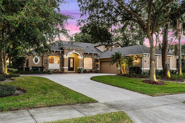 view of front of house featuring a yard and a garage