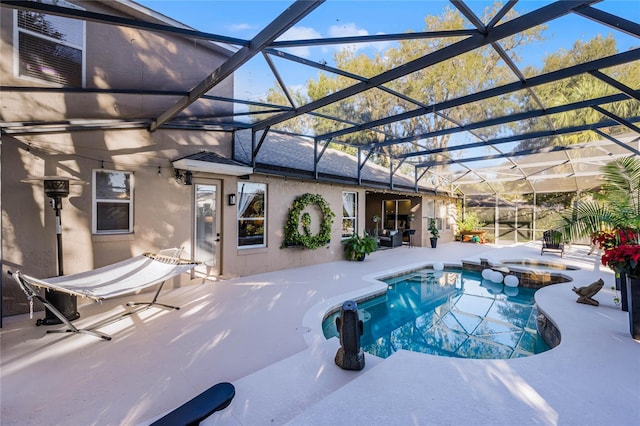 view of swimming pool with a lanai, an in ground hot tub, and a patio area