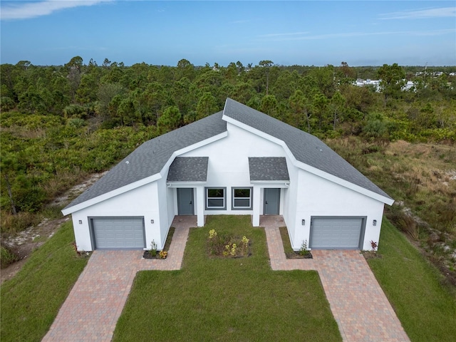 view of front facade with a garage and a front lawn