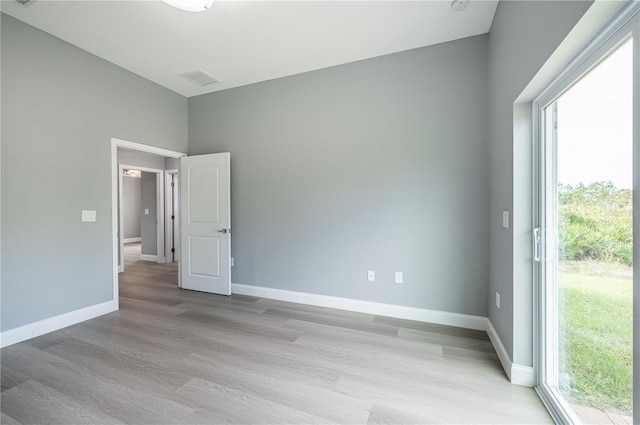 empty room featuring light hardwood / wood-style flooring and plenty of natural light