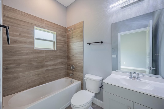 full bathroom featuring tiled shower / bath combo, toilet, and vanity