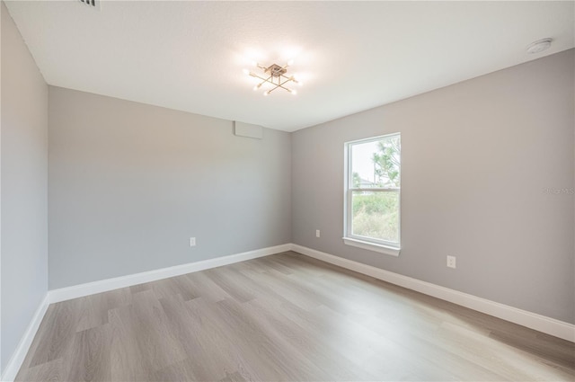 unfurnished room with light hardwood / wood-style flooring