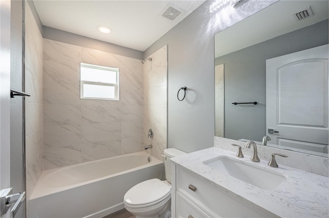 full bathroom with vanity, tiled shower / bath combo, and toilet