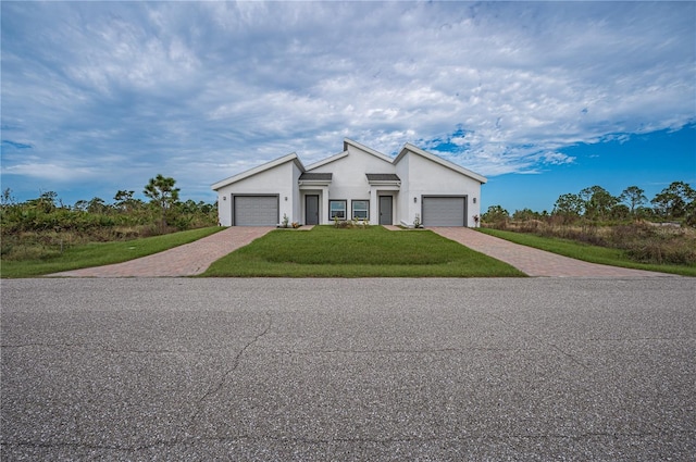 view of front facade with a front yard and a garage