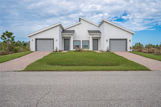 view of front of property with a garage and a front yard