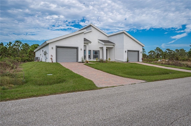 ranch-style house with a garage, central air condition unit, and a front lawn