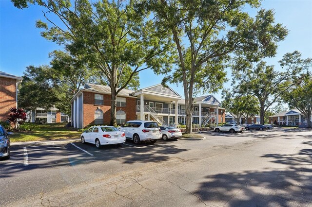 5417 Lake Margaret Dr Unit G, Orlando, FL 32812 - view of building exterior with uncovered parking and a residential view