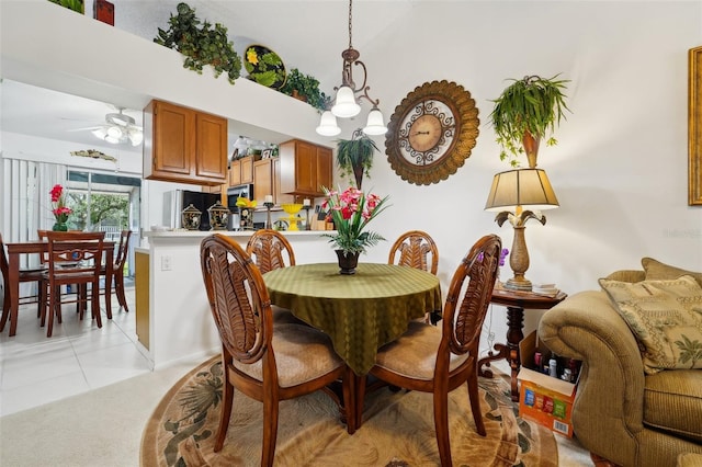 dining area featuring light tile patterned floors and ceiling fan