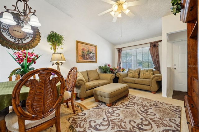 living room with a textured ceiling, ceiling fan, and lofted ceiling