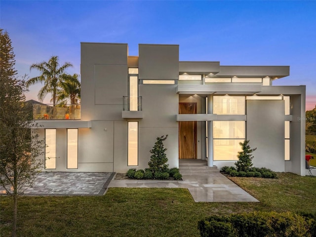 exterior space featuring a yard and stucco siding