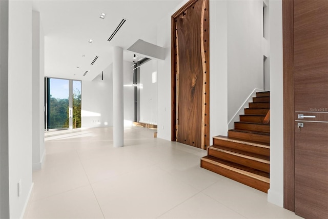 hall featuring light tile patterned floors