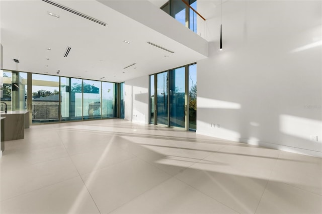 interior space featuring a healthy amount of sunlight and a wall of windows