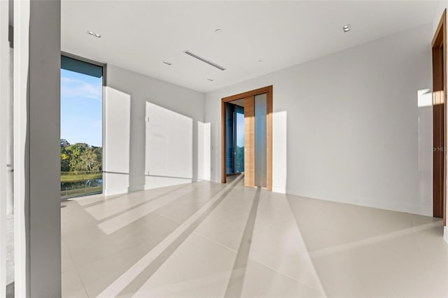 empty room featuring tile patterned floors and a wealth of natural light