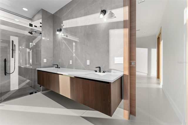 bathroom with tile patterned floors, vanity, and tile walls