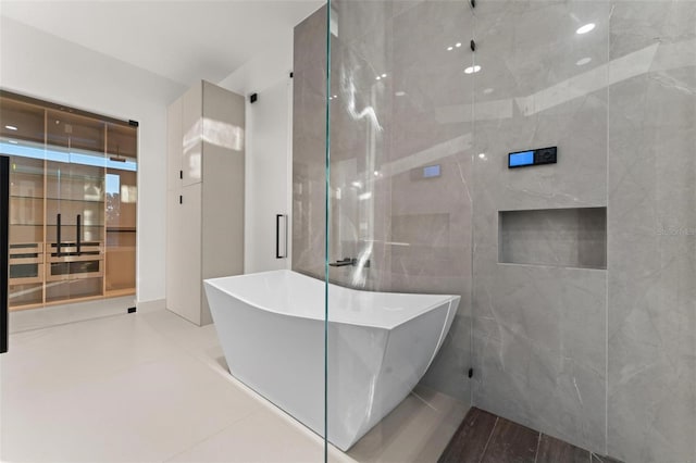 bathroom featuring tile patterned floors and a tub