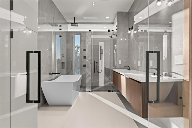 bathroom featuring vanity, tile patterned floors, tile walls, and independent shower and bath