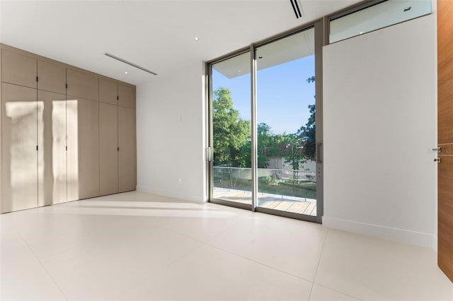 unfurnished bedroom featuring access to exterior and light tile patterned floors