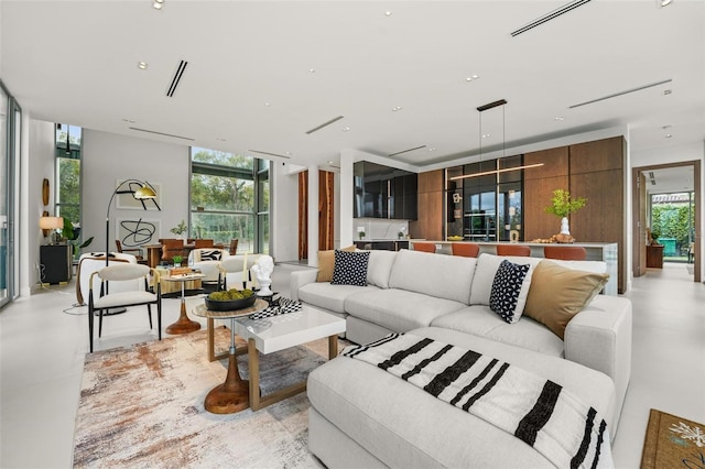 living room featuring expansive windows, visible vents, and recessed lighting