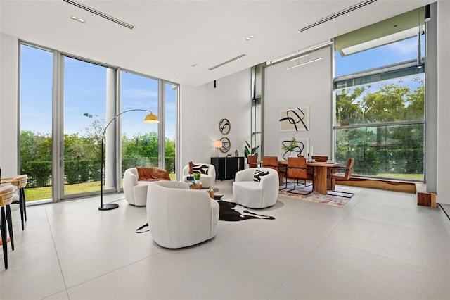 sitting room featuring expansive windows and visible vents