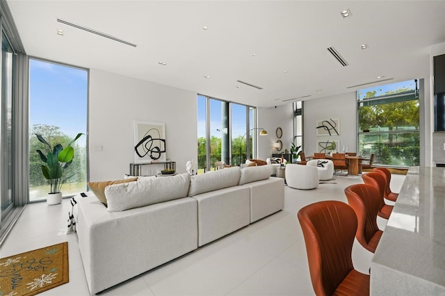 living room featuring expansive windows and visible vents