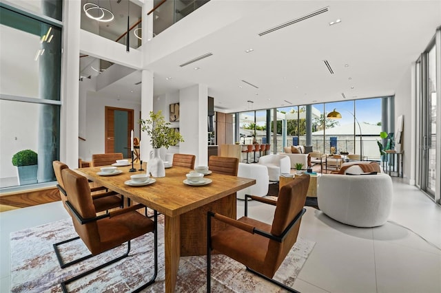 dining area featuring expansive windows and visible vents