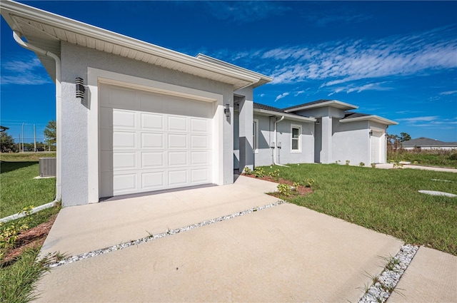 ranch-style home featuring a front lawn, central AC unit, and a garage