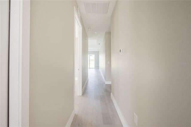 corridor with light hardwood / wood-style floors