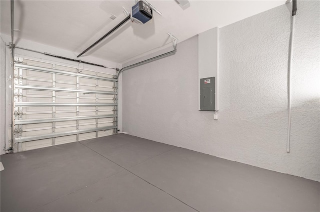 garage with electric panel and a garage door opener