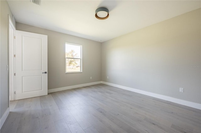 unfurnished room with light hardwood / wood-style floors