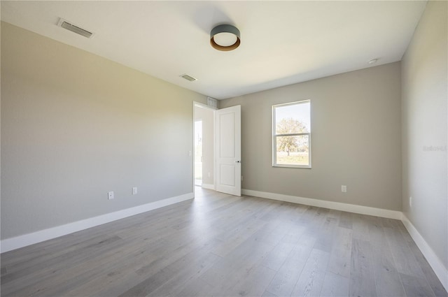 spare room with light hardwood / wood-style flooring