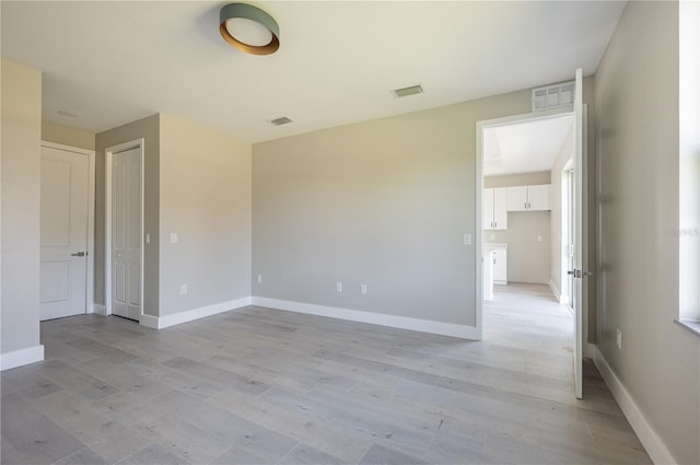 spare room with light wood-type flooring