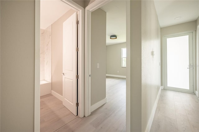 corridor with light wood-type flooring