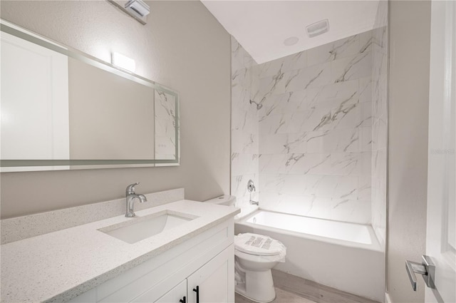 full bathroom featuring vanity, toilet, and tiled shower / bath