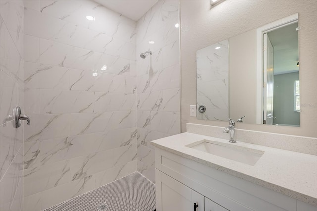 bathroom featuring vanity and a tile shower