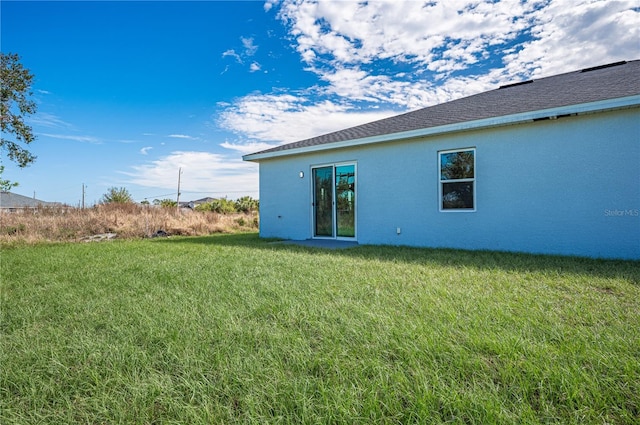 rear view of house with a yard