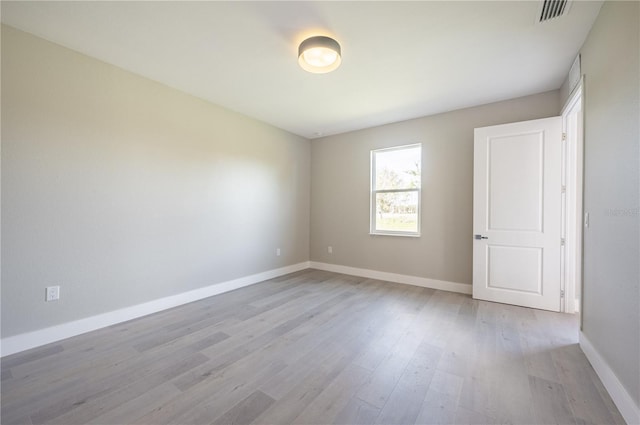 empty room with light hardwood / wood-style flooring