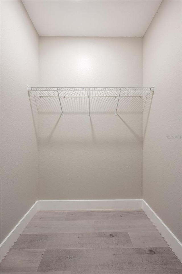 walk in closet featuring hardwood / wood-style flooring