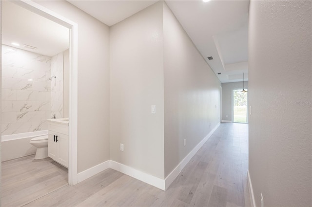 hall with light wood-type flooring