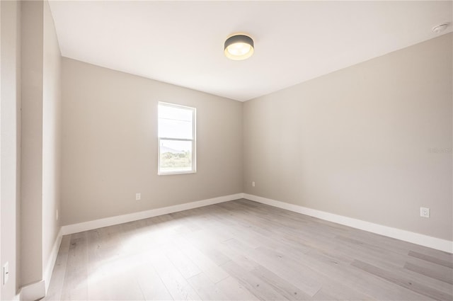 unfurnished room with light wood-type flooring