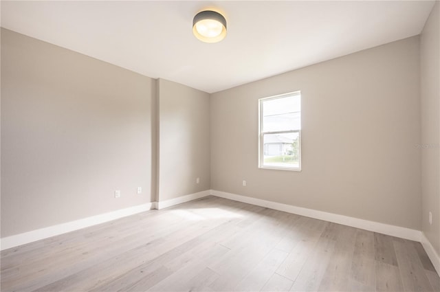 unfurnished room with light wood-type flooring