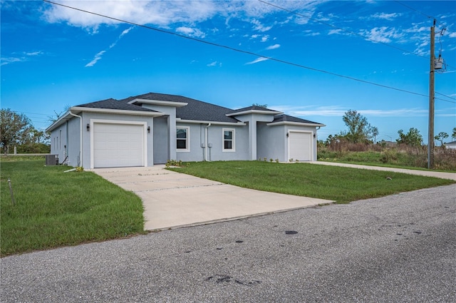 ranch-style home featuring central AC, a garage, and a front lawn